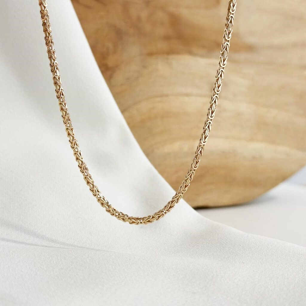 Königskette aus 585er Gelbgold mit kunstvoll geflochtenem 1,8mm Muster und 50cm Länge, präzise verarbeitet und in eleganter Nahaufnahme gezeigt.